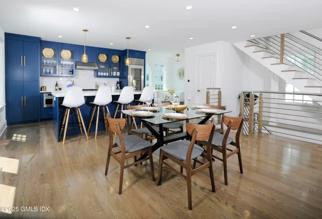 a view of a dining room with furniture and wooden floor