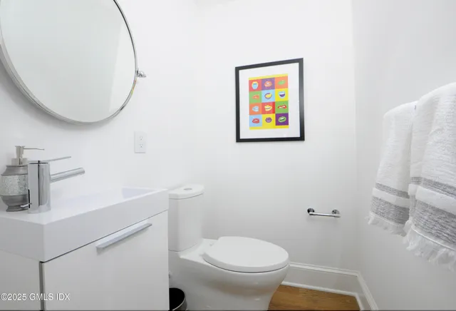 a white toilet sitting next to a bathroom sink