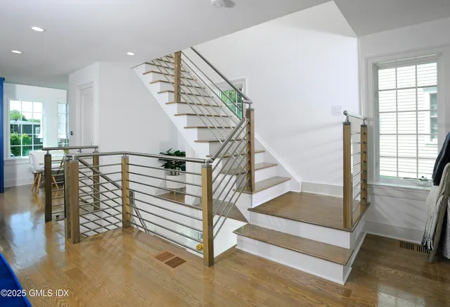 a view of entryway and hall with wooden floor
