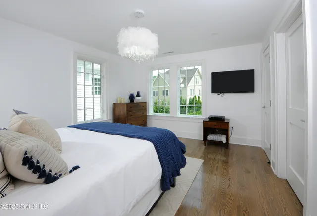 a bedroom with a bed window and a table