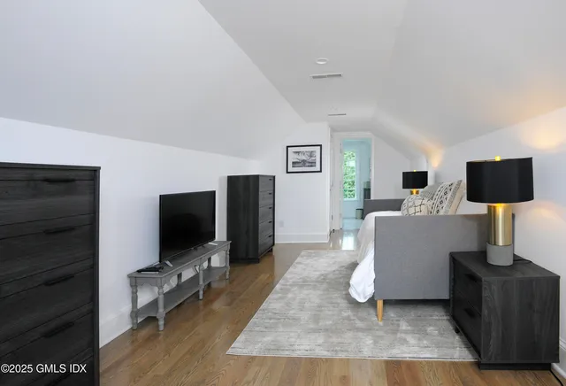 a bathroom with a granite countertop sink a toilet and shower