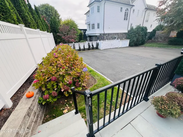 a view of a back yard of the house with sitting area