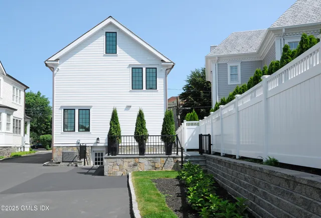 an aerial view of a house with wooden fence