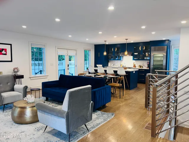 a living room with furniture a window and kitchen view