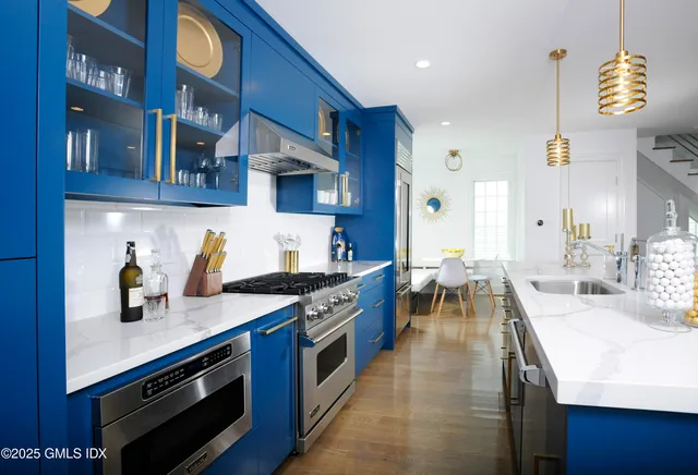 a kitchen with stainless steel appliances granite countertop a stove and a sink