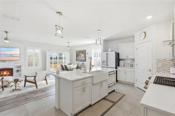 a kitchen with white cabinets and sink
