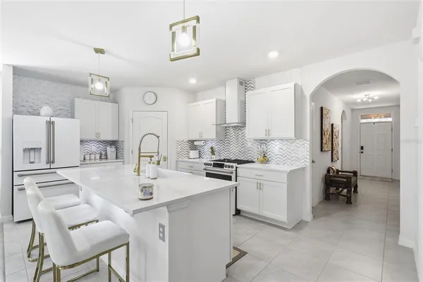 a kitchen with a sink stove and cabinets