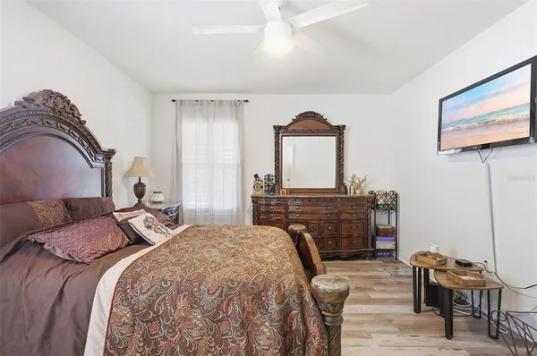 a bedroom with a bed and a television