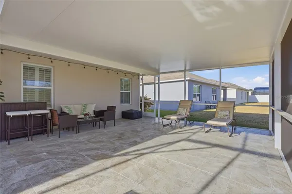 a living room with furniture a window and a table