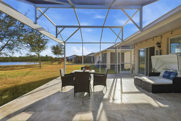 a view of a swimming pool with a couches in a patio