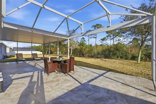 a view of a patio with a table and chairs under an umbrella