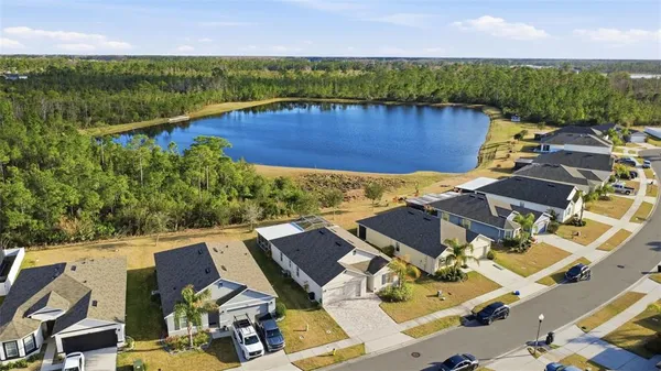 an aerial view of residential house with outdoor space and lake view
