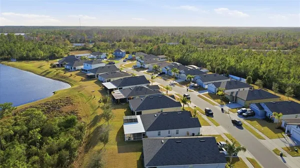 an aerial view of a houses with a lake view