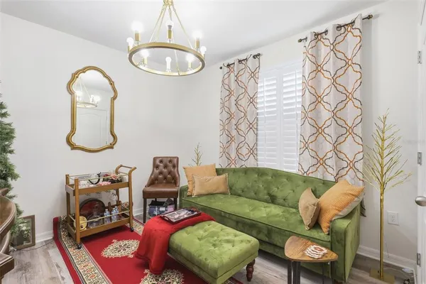 a living room with furniture and a mirror