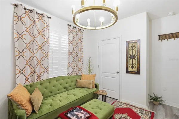 a living room with a couch and a chandelier