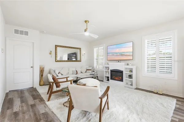 a living room with furniture a fireplace and a table