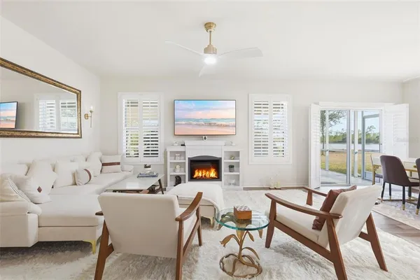 a living room with furniture a fireplace and a table