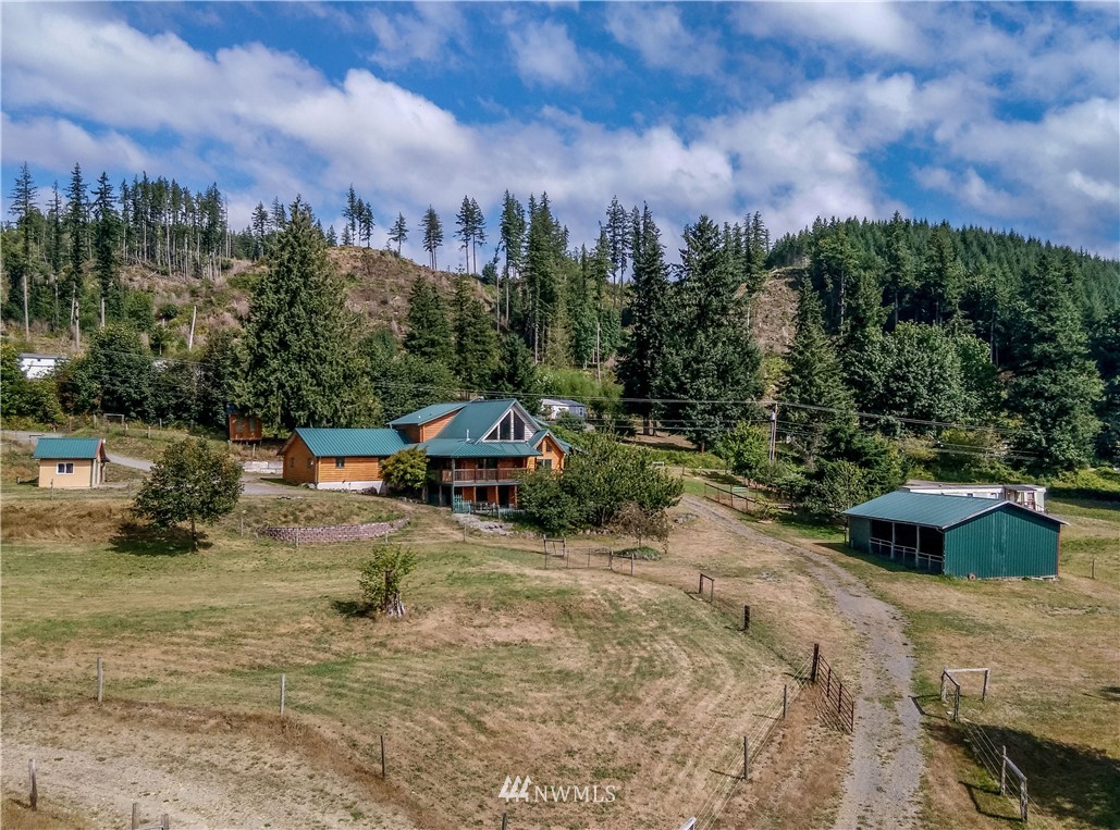 1072 Dabob Road Quilcene, WA 98376 - Photo 1 of 25 a view of a house with a yard