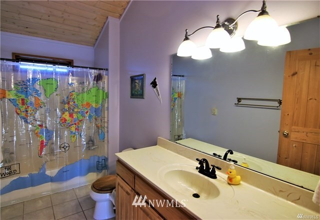 1072 Dabob Road Quilcene, WA 98376 - Photo 12 of 25 a bathroom with a sink mirror and vanity