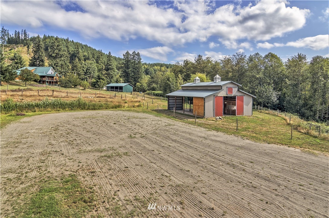 1072 Dabob Road Quilcene, WA 98376 - Photo 18 of 25 a view of a house with a yard