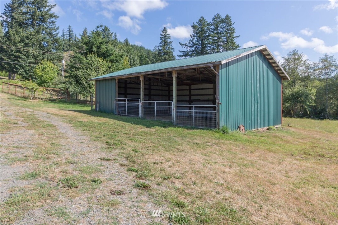 1072 Dabob Road Quilcene, WA 98376 - Photo 23 of 25 a view of a house with a yard and garage