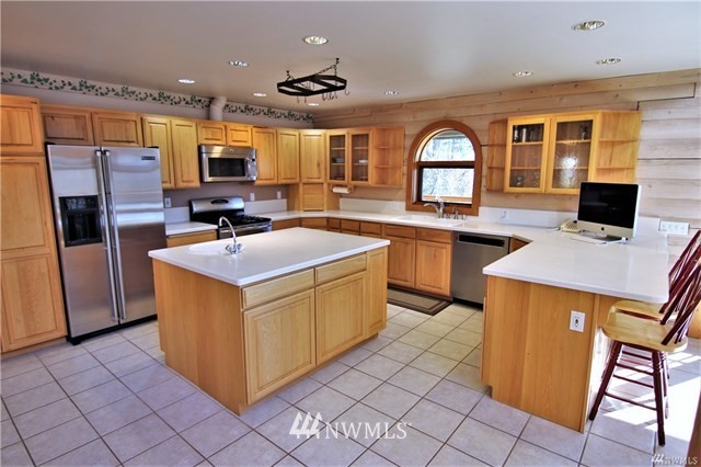 1072 Dabob Road Quilcene, WA 98376 - Photo 8 of 25 a kitchen with stainless steel appliances granite countertop a stove top oven a sink a counter top space and cabinets