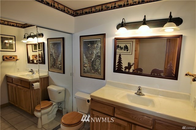 1072 Dabob Road Quilcene, WA 98376 - Photo 10 of 25 a bathroom with a toilet sink and mirror