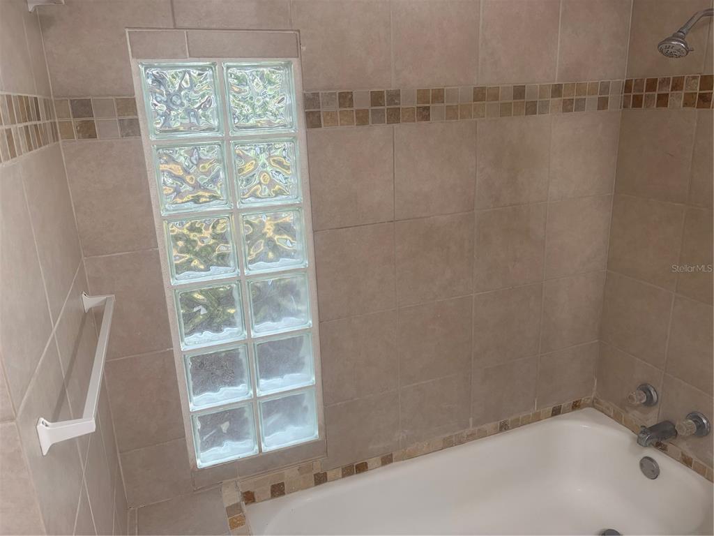 8302 Split Rail Lane Hudson, FL 34667 - Photo 11 of 21 a bathroom with bathtub and shower