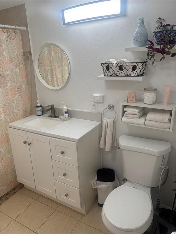 8302 Split Rail Lane Hudson, FL 34667 - Photo 12 of 21 a bathroom with a toilet a sink and a mirror