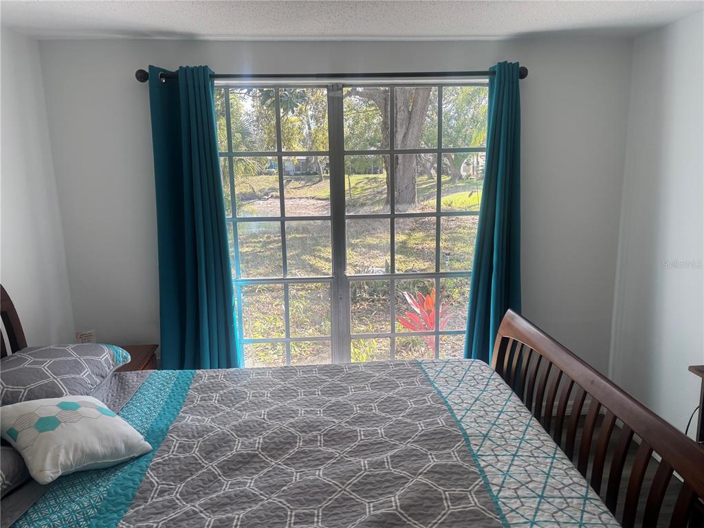 8302 Split Rail Lane Hudson, FL 34667 - Photo 13 of 21 a bedroom with a large bed and a large window