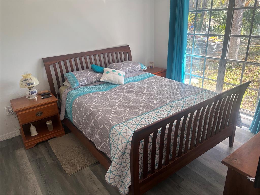 8302 Split Rail Lane Hudson, FL 34667 - Photo 15 of 21 a bed sitting in a bedroom next to a window