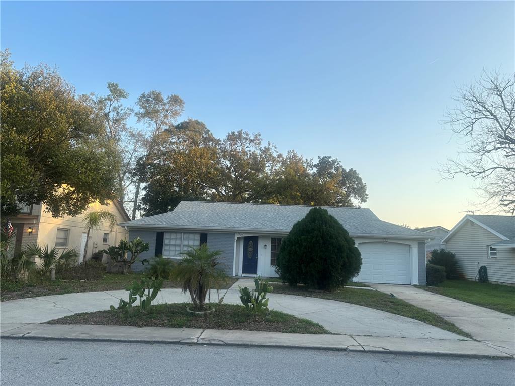 8302 Split Rail Lane Hudson, FL 34667 - Photo 2 of 21 a front view of a house with a yard and potted plants