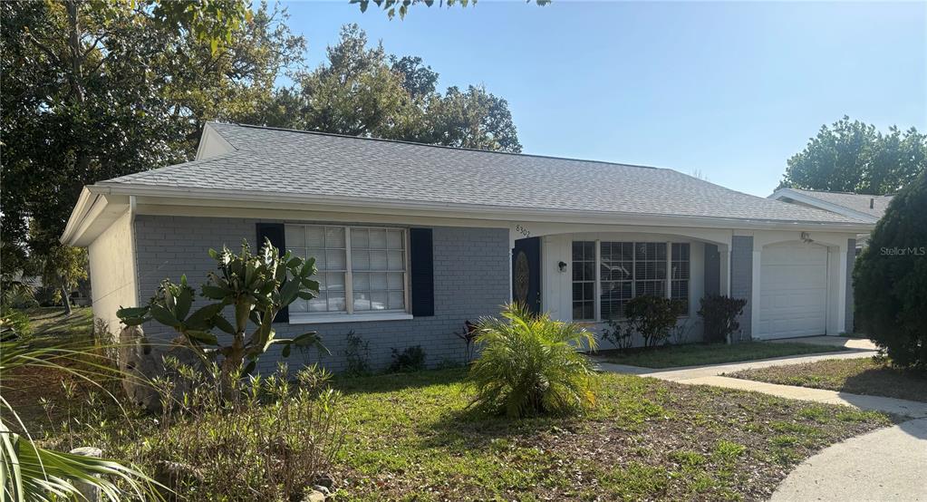 8302 Split Rail Lane Hudson, FL 34667 - Photo 3 of 21 a front view of a house with garden