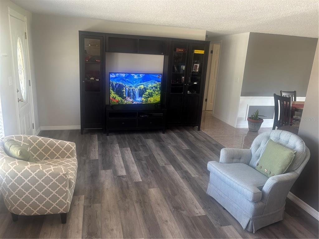 8302 Split Rail Lane Hudson, FL 34667 - Photo 9 of 21 a living room with furniture and a flat screen tv