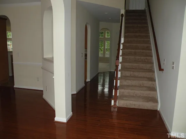 a view of entryway and hall with wooden floor