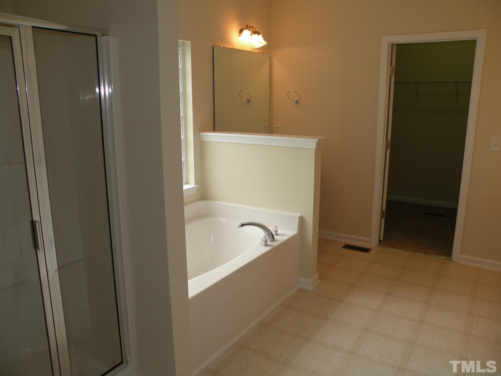 4733 Porchaven Lane Apex, NC 27539 - Photo 14 of 25 a bathroom with a bathtub and shower