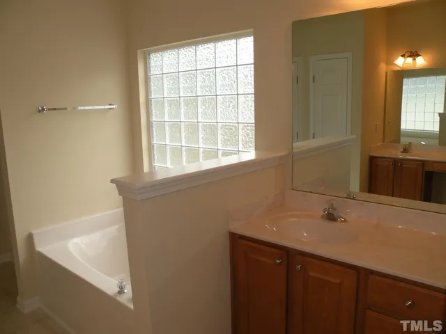 a bathroom with a sink and a window