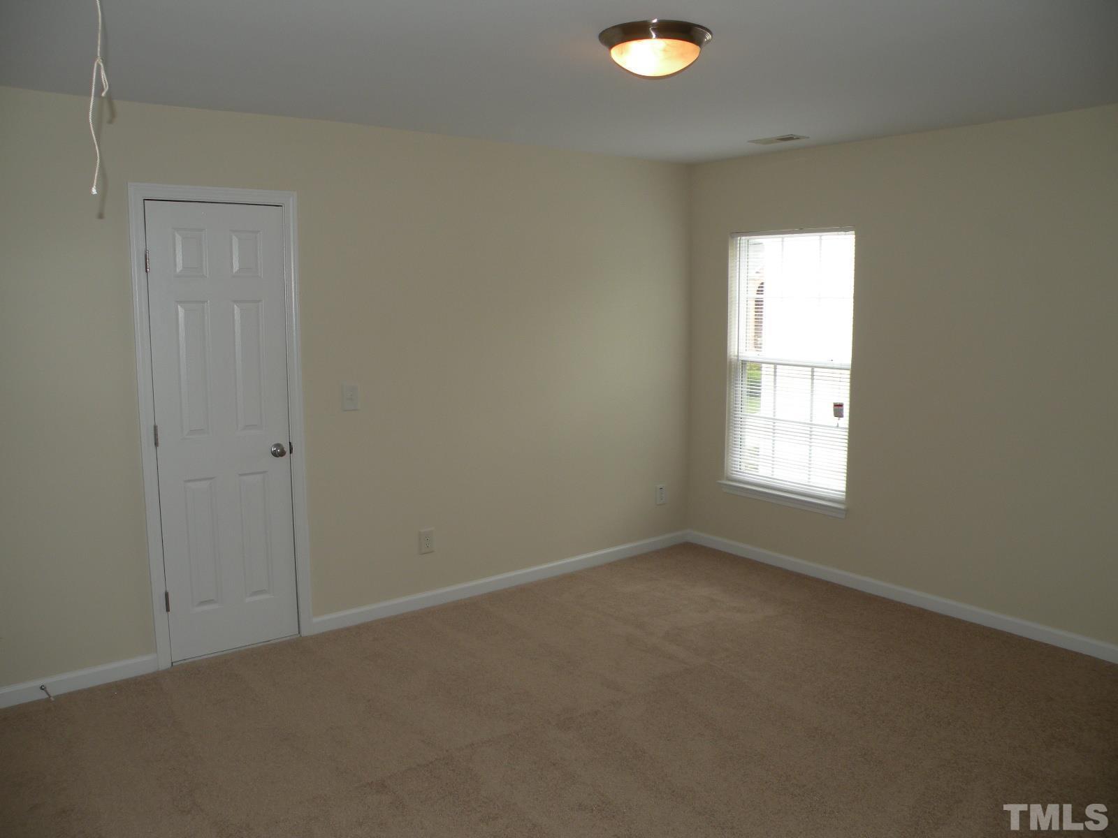 4733 Porchaven Lane Apex, NC 27539 - Photo 19 of 25 an empty room with a window