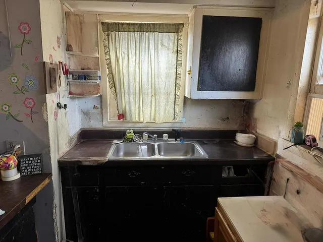 a kitchen with a sink stove and cabinets