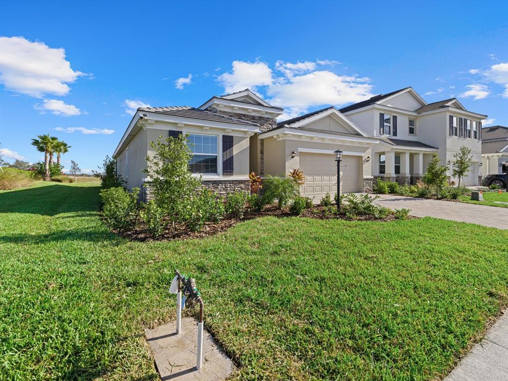 17707 Gulf Rnch Place Bradenton, FL 34211 - Photo 2 of 27 a front view of a house with garden