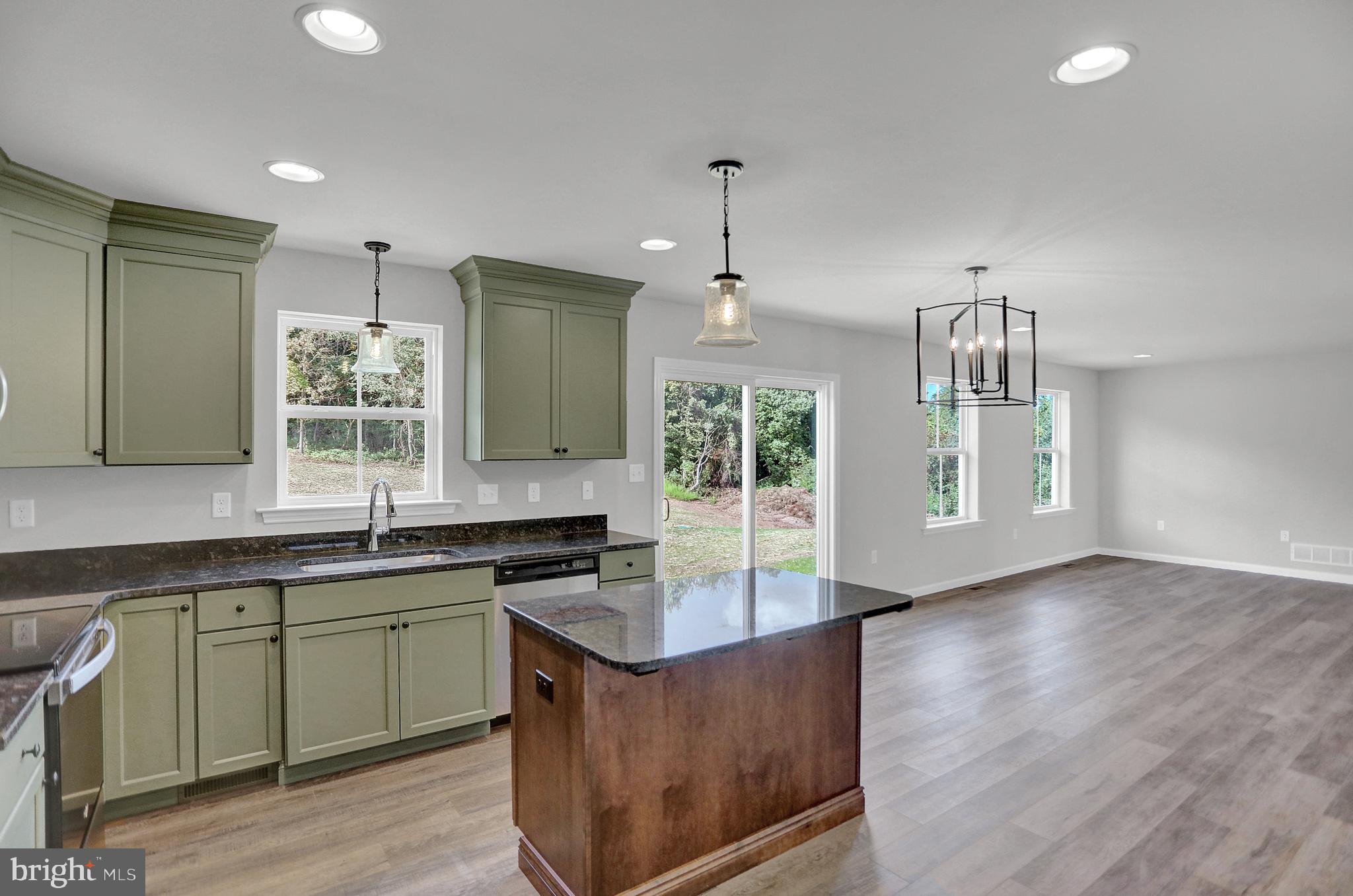 58 Pine Tree Drive Duncannon, PA 17020 - Photo 21 of 53 a kitchen with stainless steel appliances granite countertop a sink a stove and a wooden floors
