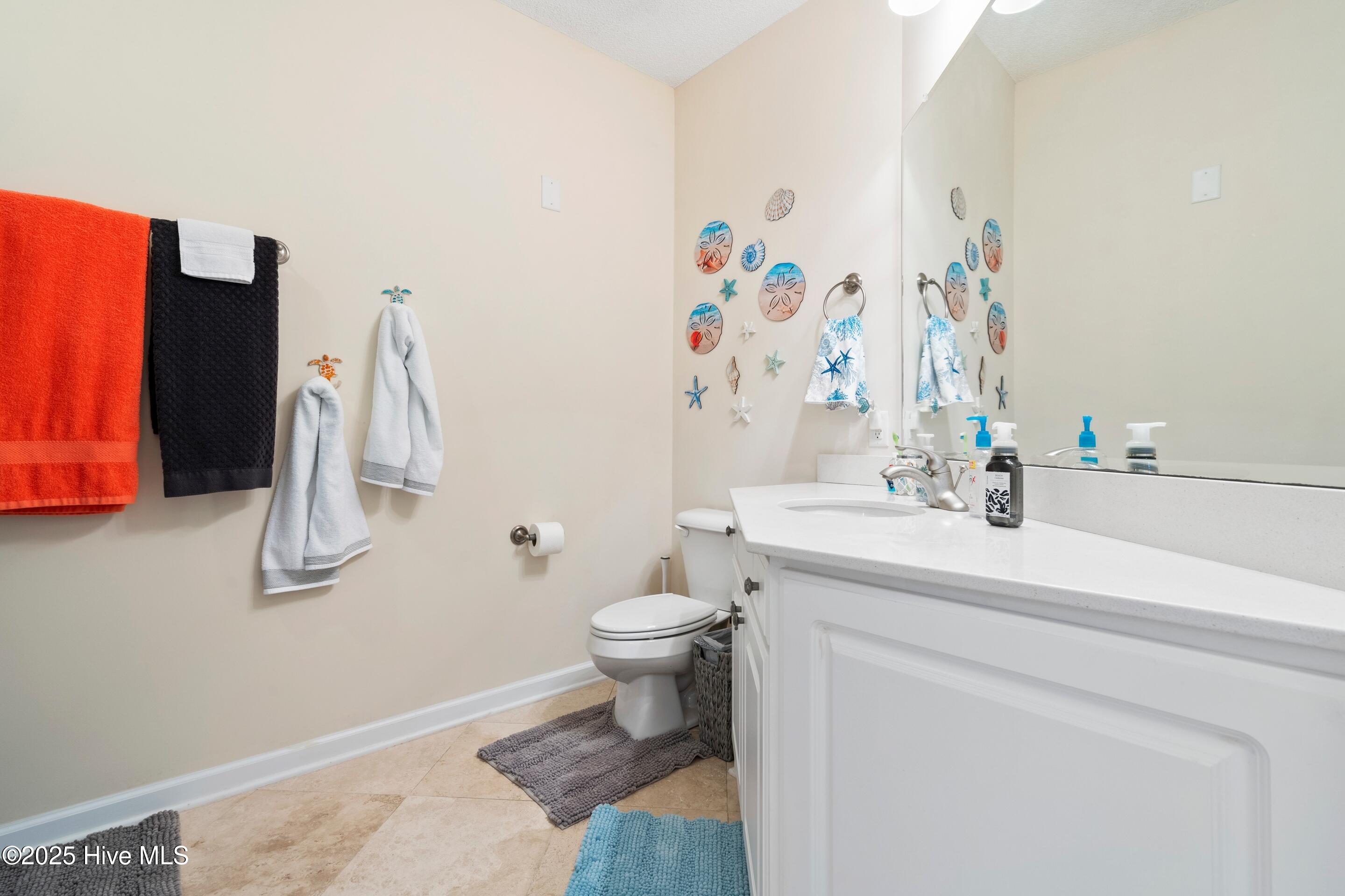 1135 Park Road Southwest, Unit 2304 Sunset Beach, NC 28468 - Photo 30 of 45 Main/guest bathroom with tub and vanity