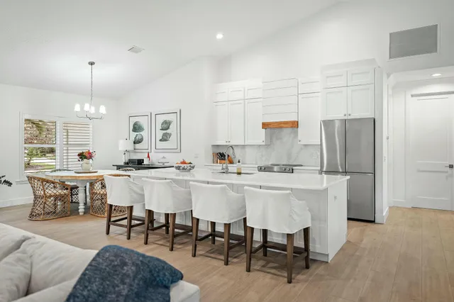 a large kitchen with a table and chairs