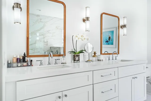 a bathroom with double vanity sink a mirror and a