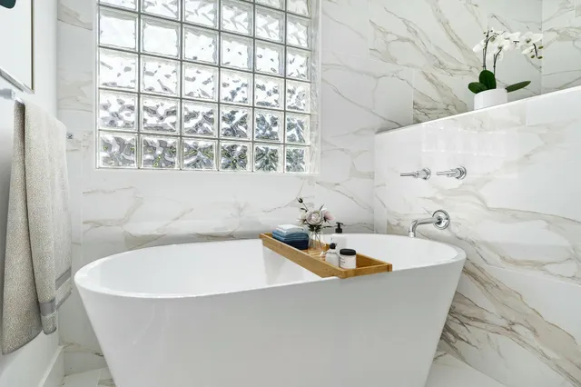 a bathroom with a bathtub and a shower
