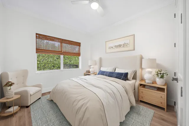 a bedroom with a bed and wooden floor