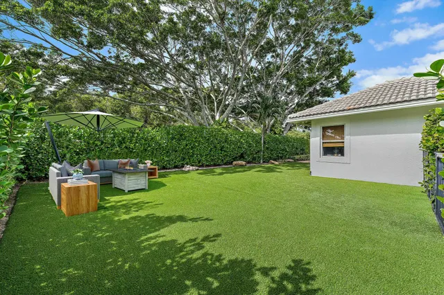 a view of backyard of house with green space