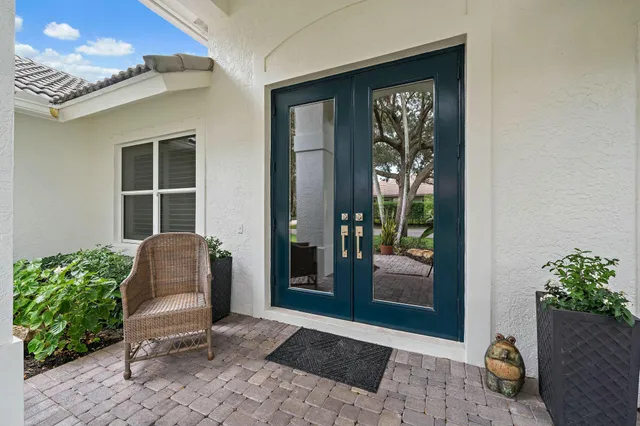 a hallway with two chair and a potted plant