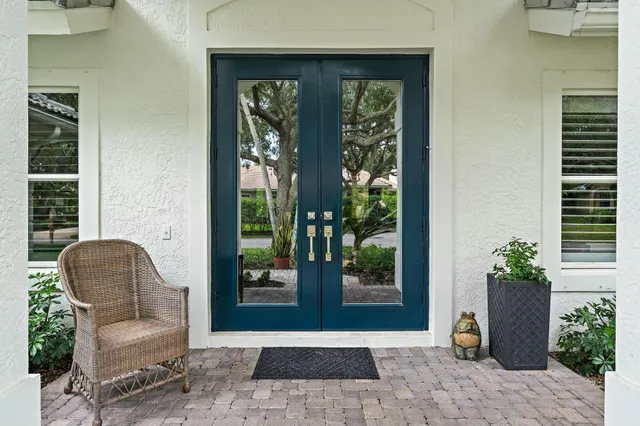 a living room with furniture and potted plants