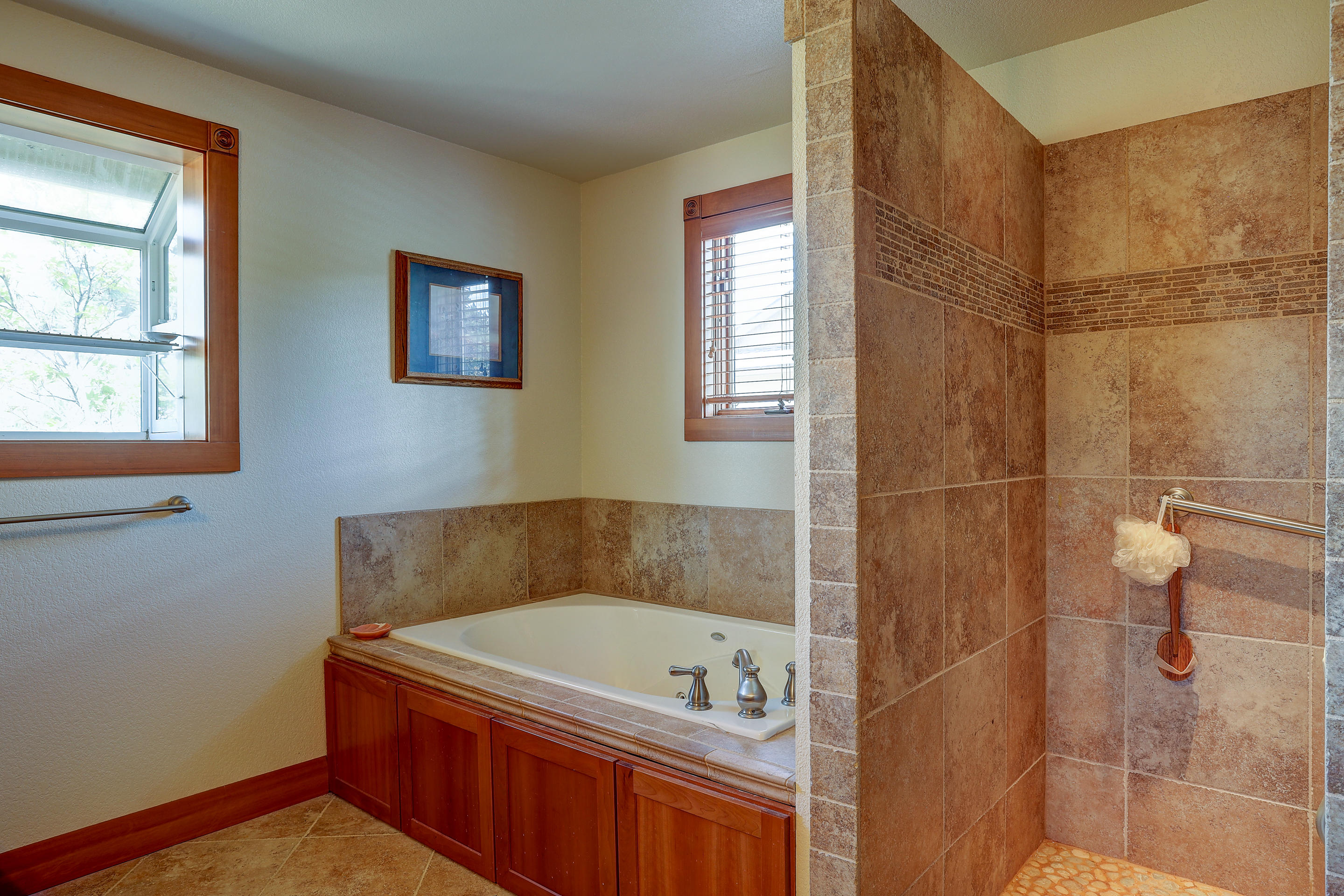 60430 Woodside Road Bend, OR 97702 - Photo 15 of 18 a bathroom with a tub a sink and a shower
